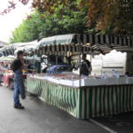 Someone buying food from a stall at the Weekly Town Market in Bradford on Avon