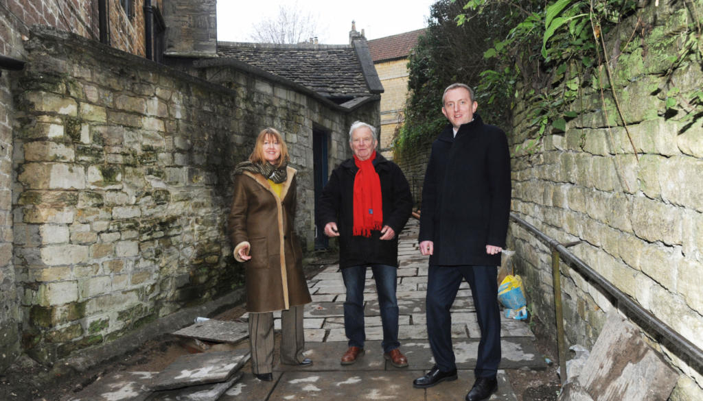 Mayor of Bradford on Avon Sarah Gibson, John Potter and Wiltshire Councillor Dr Mark McClelland explain the reason for the replacement of tarmac for Welsh Pennant Stone on Church Street