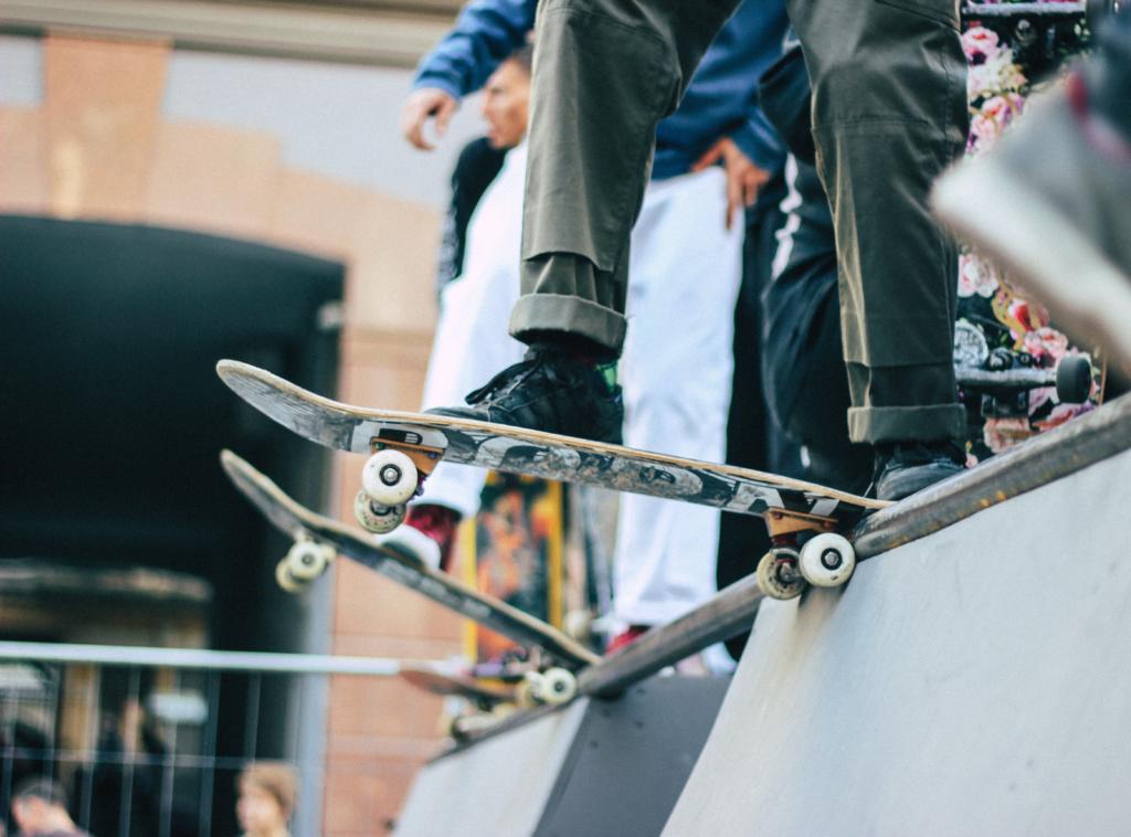 close up of skaters about to drop onto a half pipe