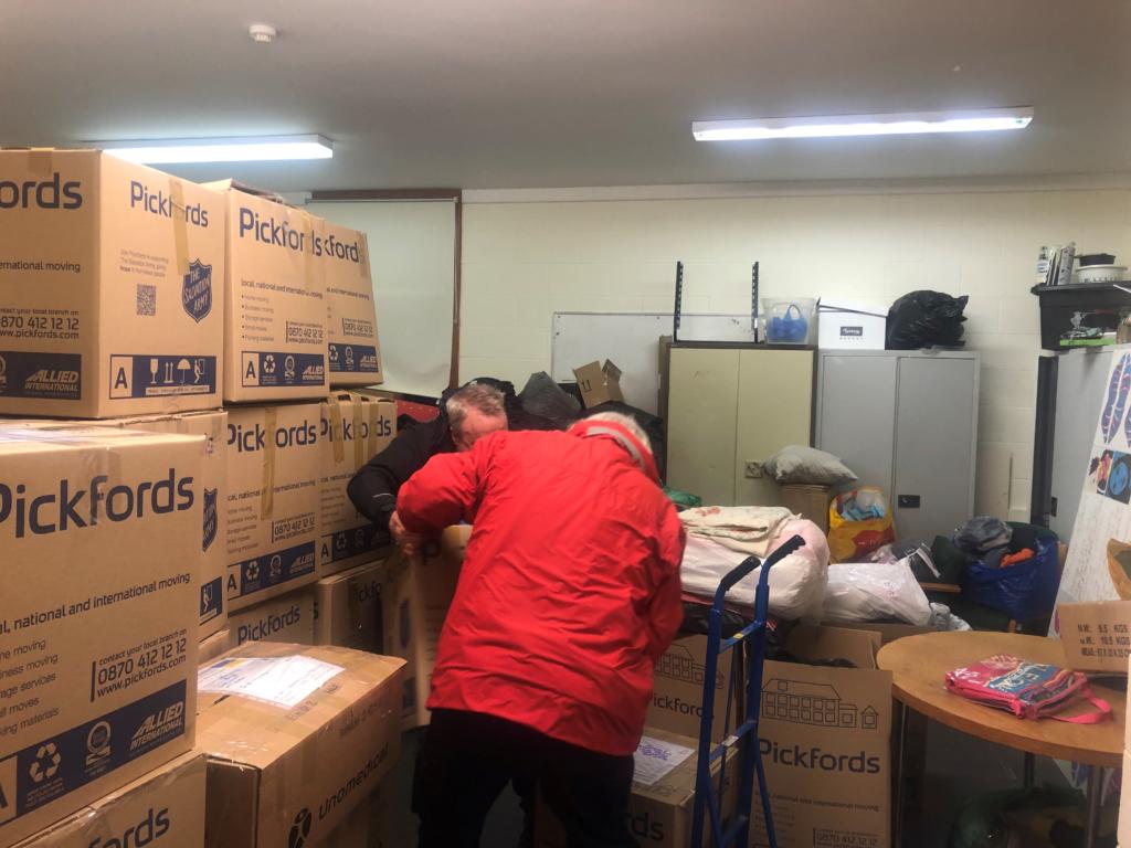 Volunteers sorting through boxes of donations