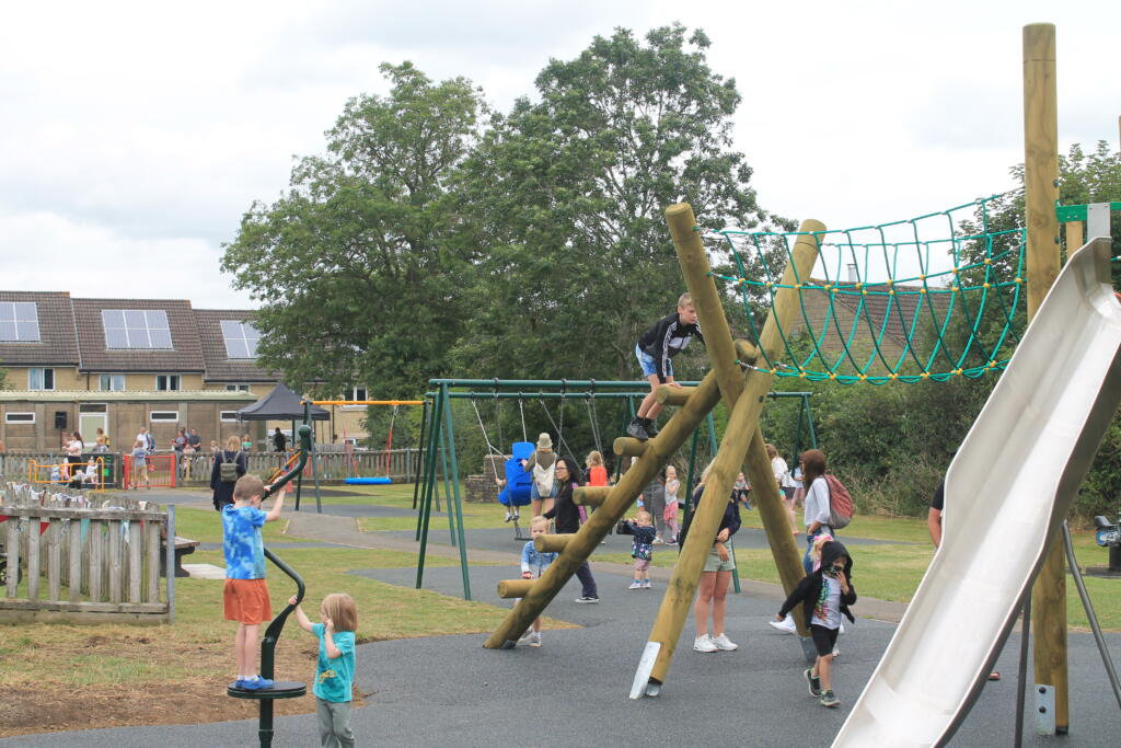 Children playing on the new climbing frame in Poulton play area.